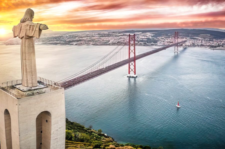 portugal statue overlooking bridge